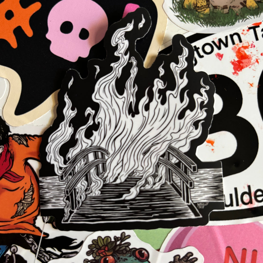a sticker that shows a bridge on fire with a wall of flames