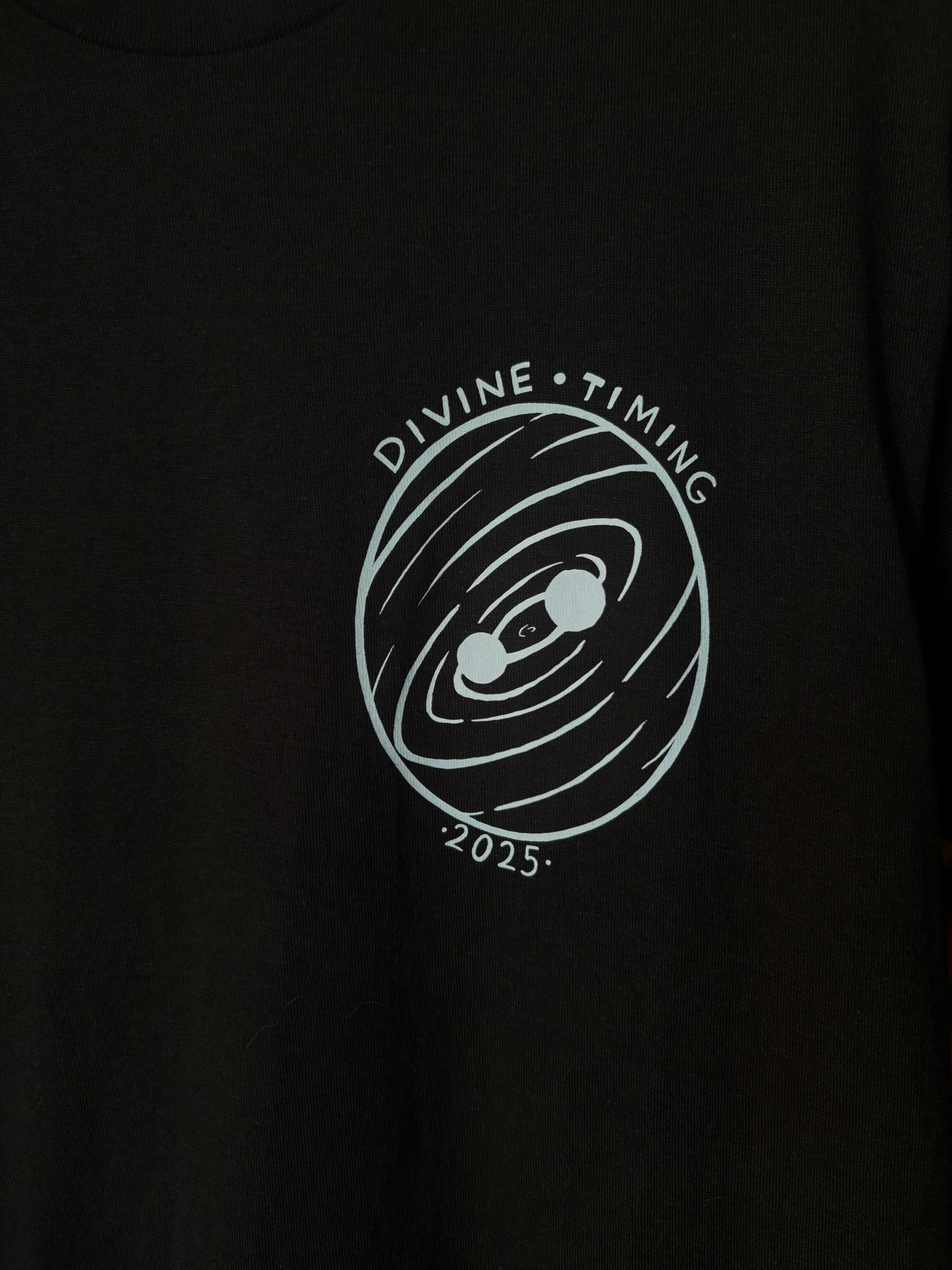 closeup look at the Divine Timing Binary Star badge printed as a club patch on the front of a black t-shirt