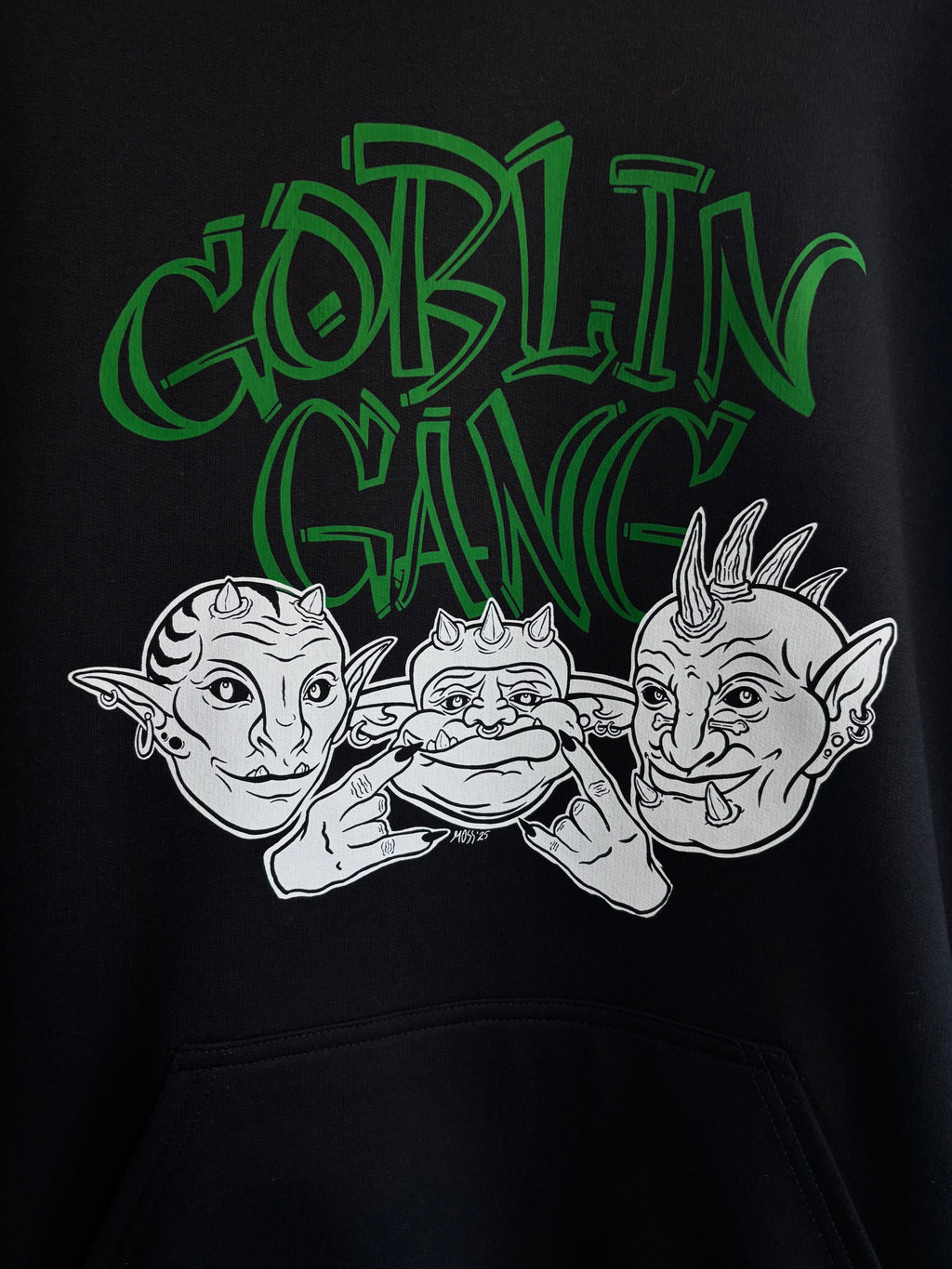 closeup look at the Goblin Gang design printed on the front of a black hoodie