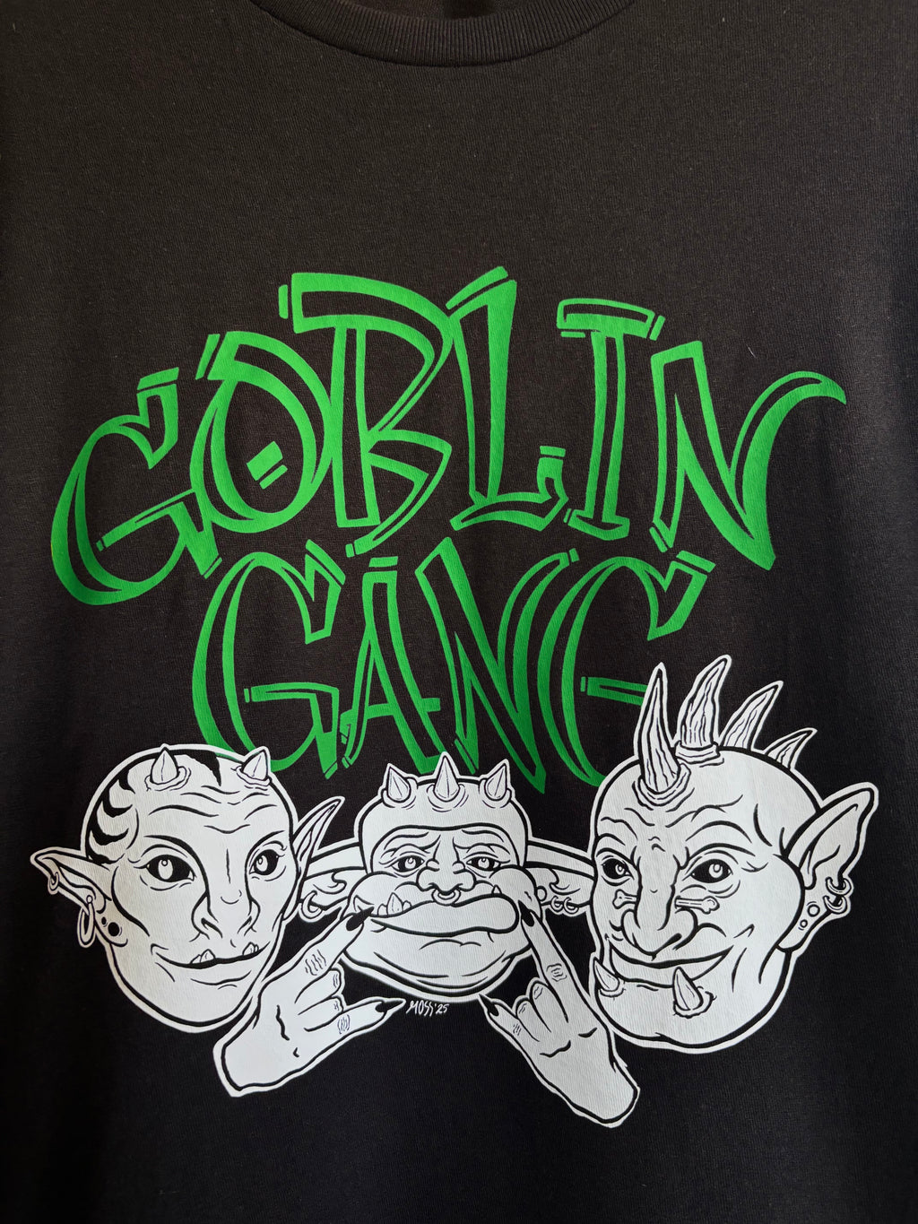 closeup look at the Goblin Gang design printed on the front of a black t-shirt