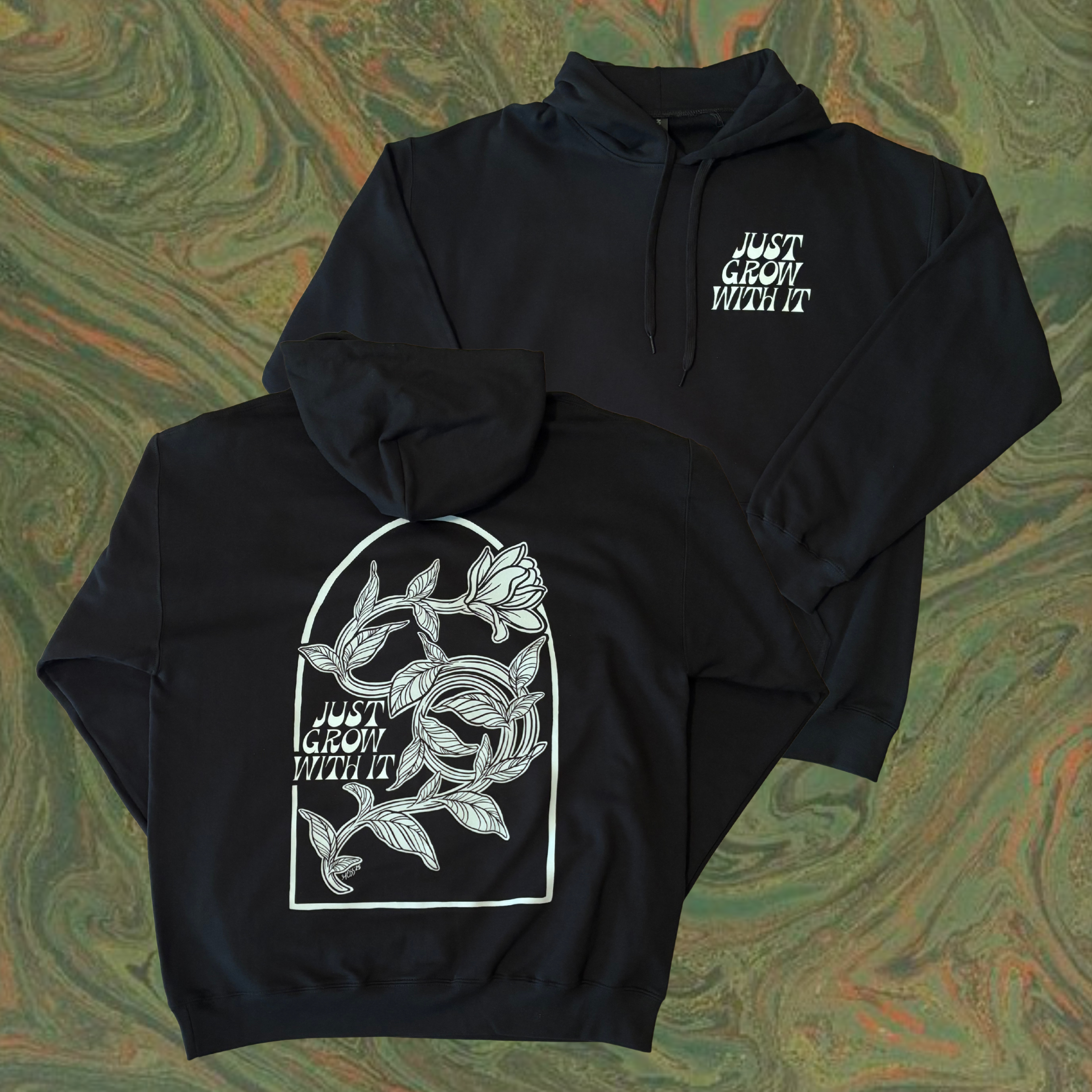 black hoodie with white floral design on the back and text that says "Just Grow With It" 