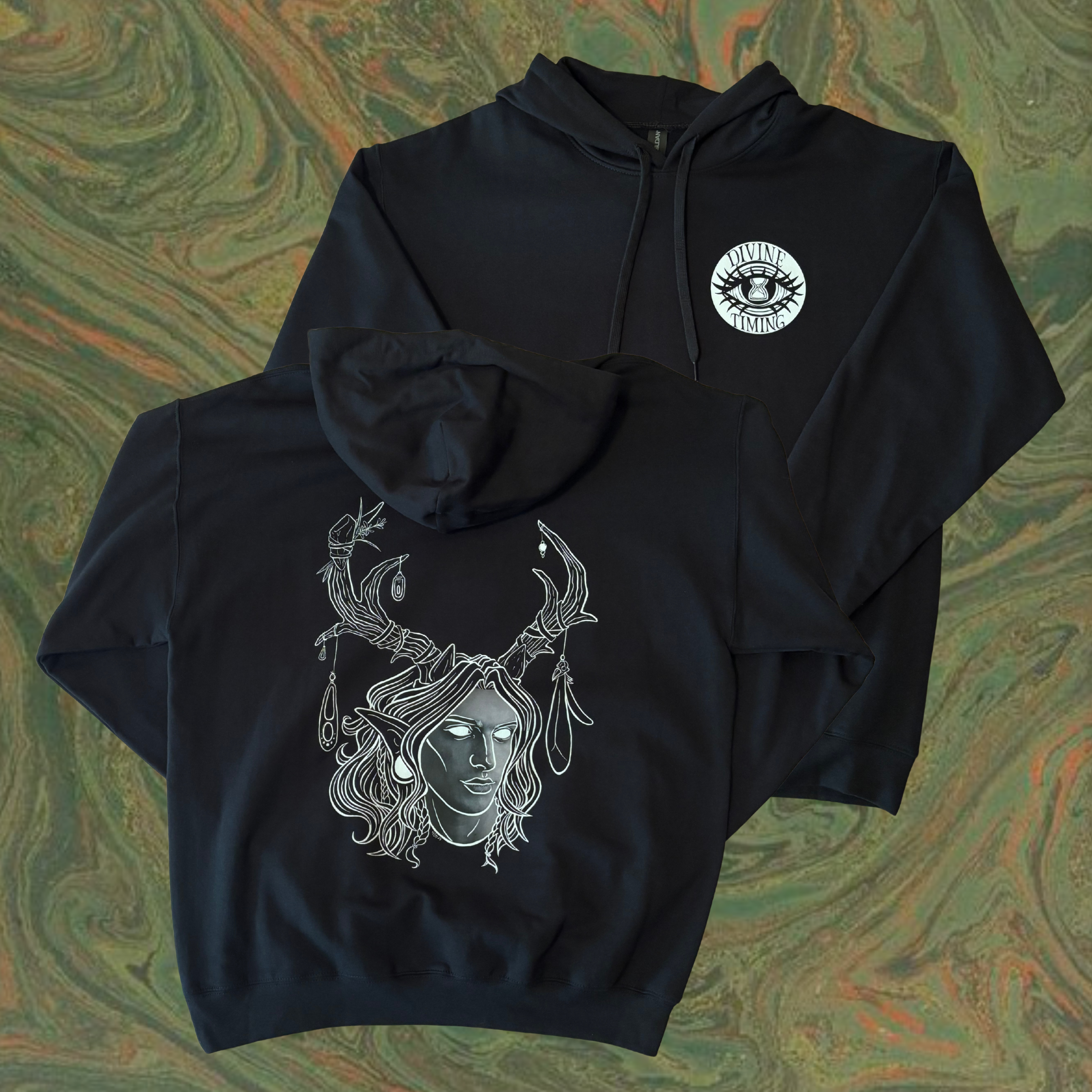 black hoodie showing the King of the Forest, a Celtic inspired fae lord, printed across the back and the Divine Timing Hourglass Eye as a club patch on the front