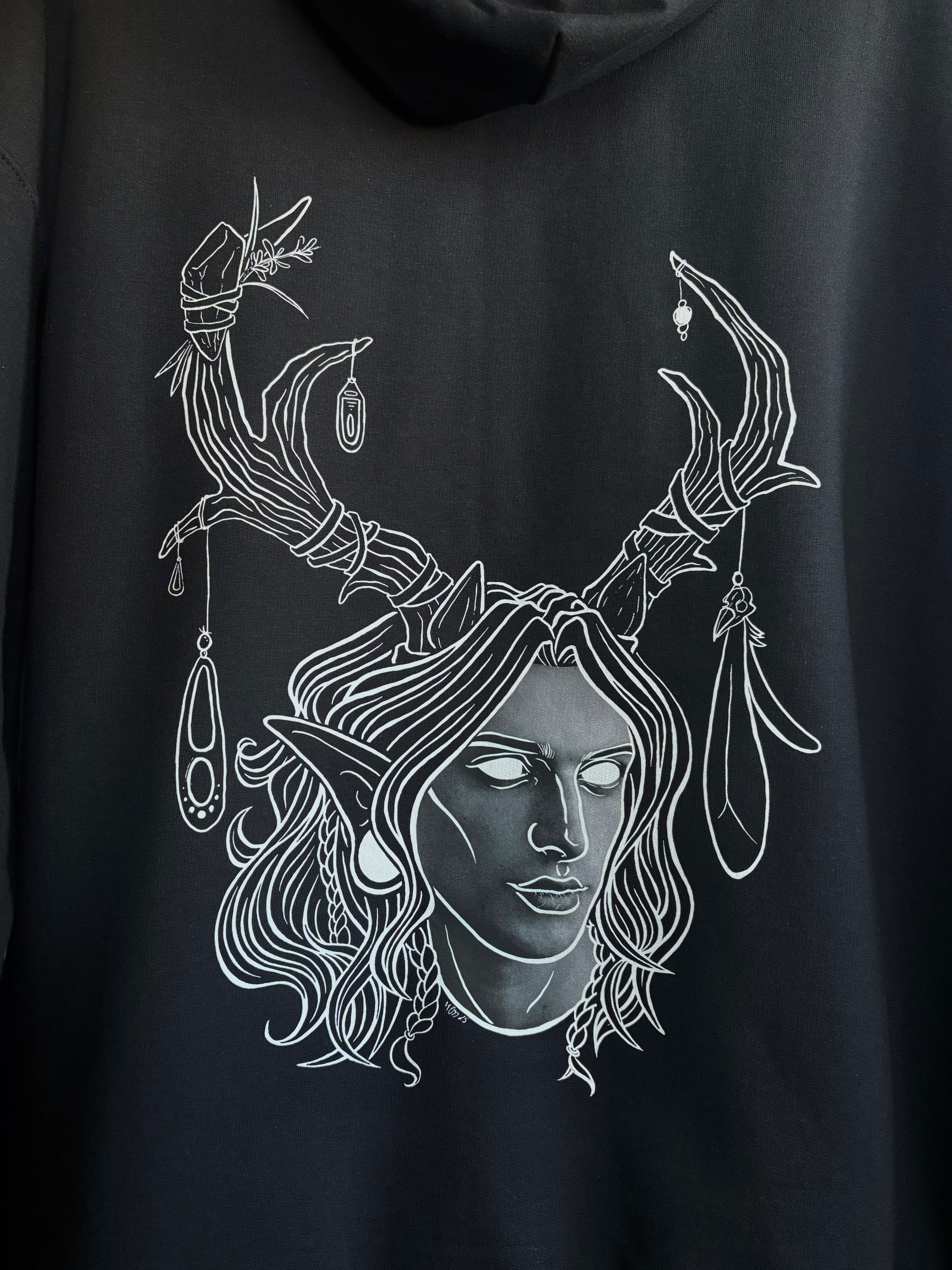 closeup look at the King of the Forest printed on the back of a black hoodie