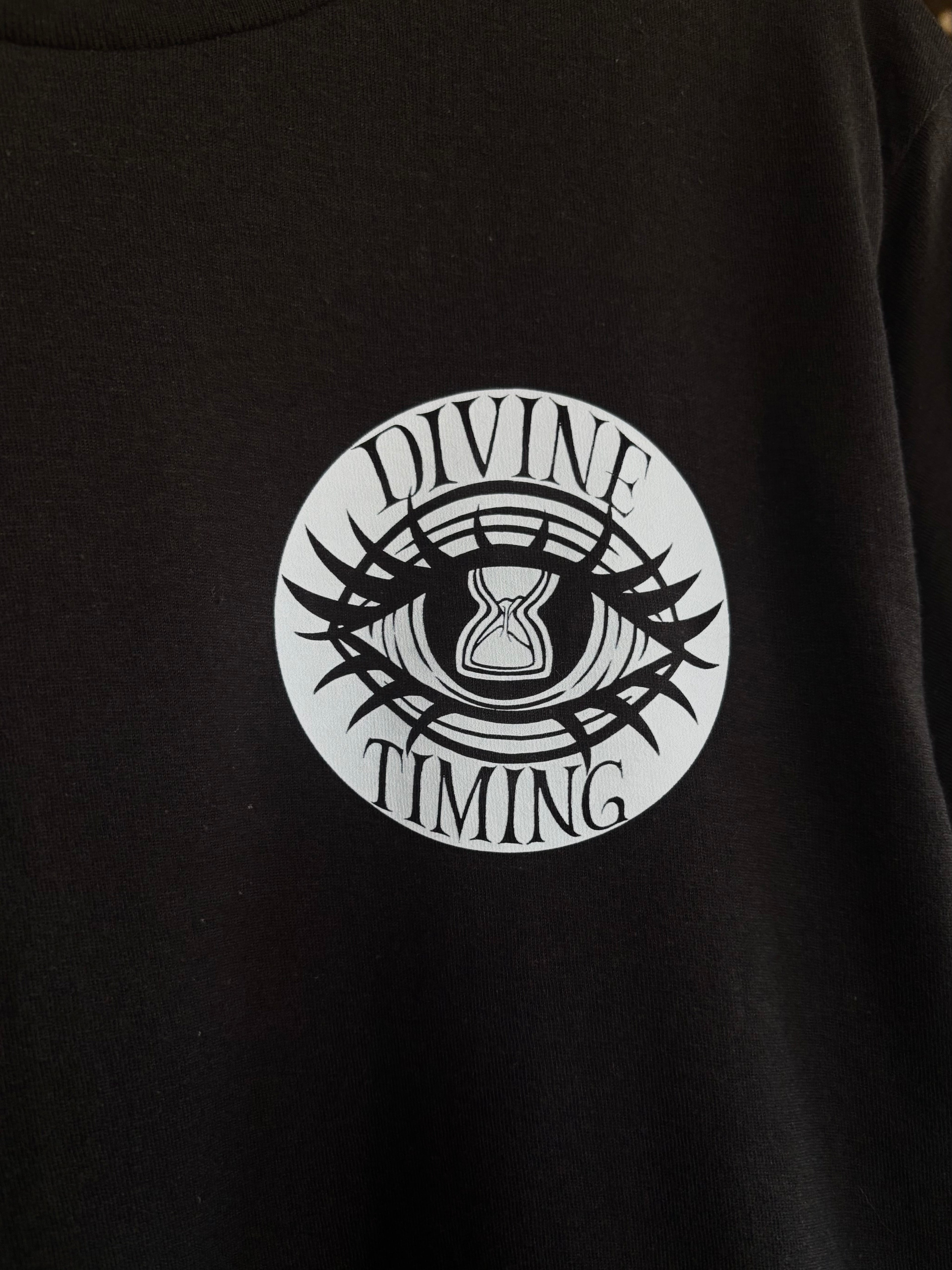 closeup look at the Divine Timing Hourglass Eye printed on the front of a black tee as a club patch