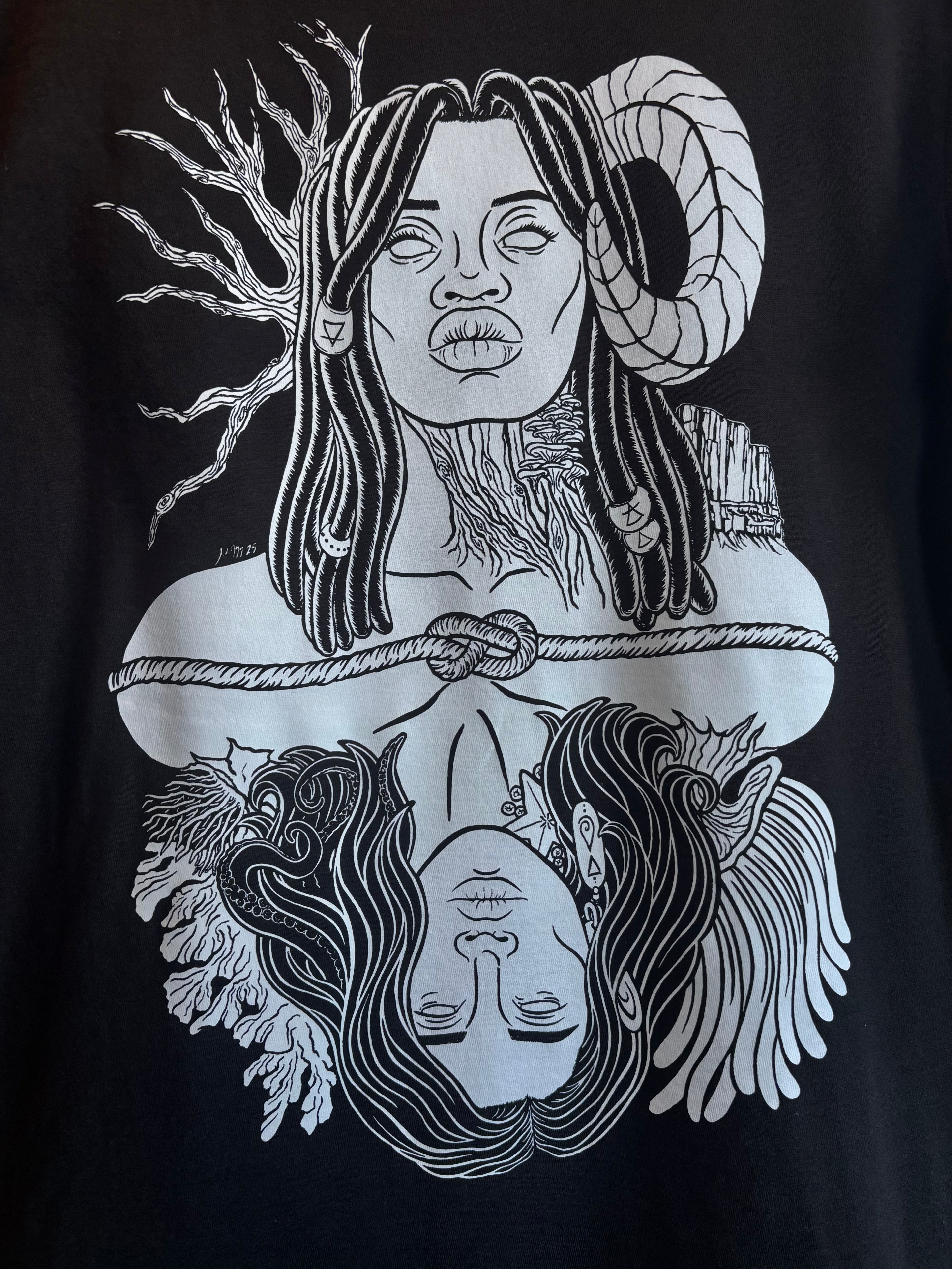 closeup look at the graphic design of Gaia, a powerful goddess adorned with beaded braids, a ram's horn, trees and mountains, who is connected to Oceanus, a god surrounded by coral and anemones with tentacles in his hair and a starfish and barnacles clinging to his neck, printed on the back of a black t-shirt