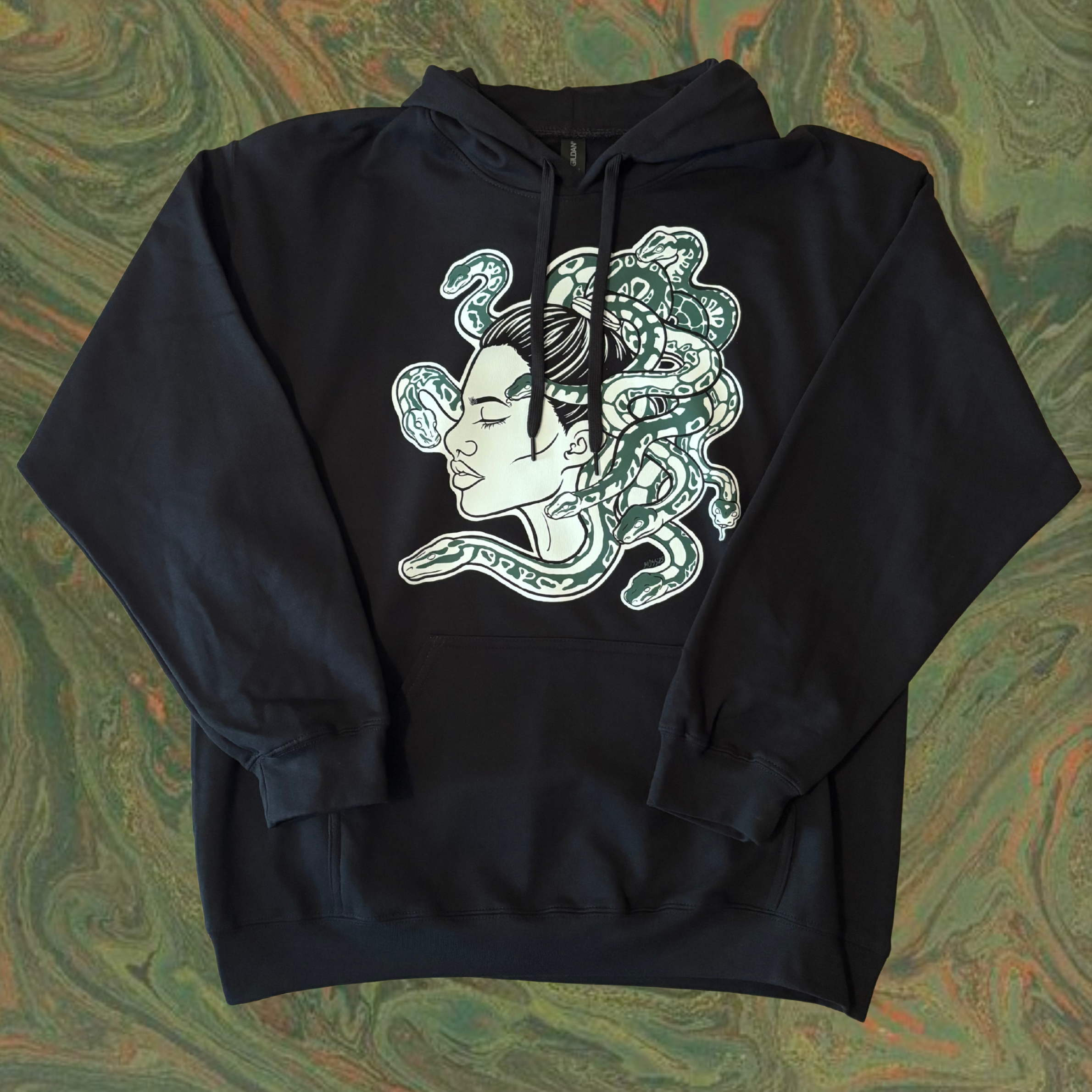 black hoodie with a Medusa graphic design printed across the chest