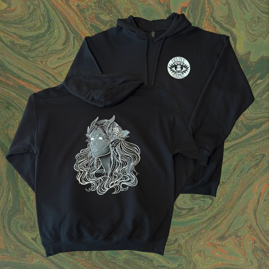 black hoodie showing the Queen of the Forest, a Celtic inspired fae goddess, printed across the back with the Divine Timing Hourglass Eye logo added as a club patch to the front