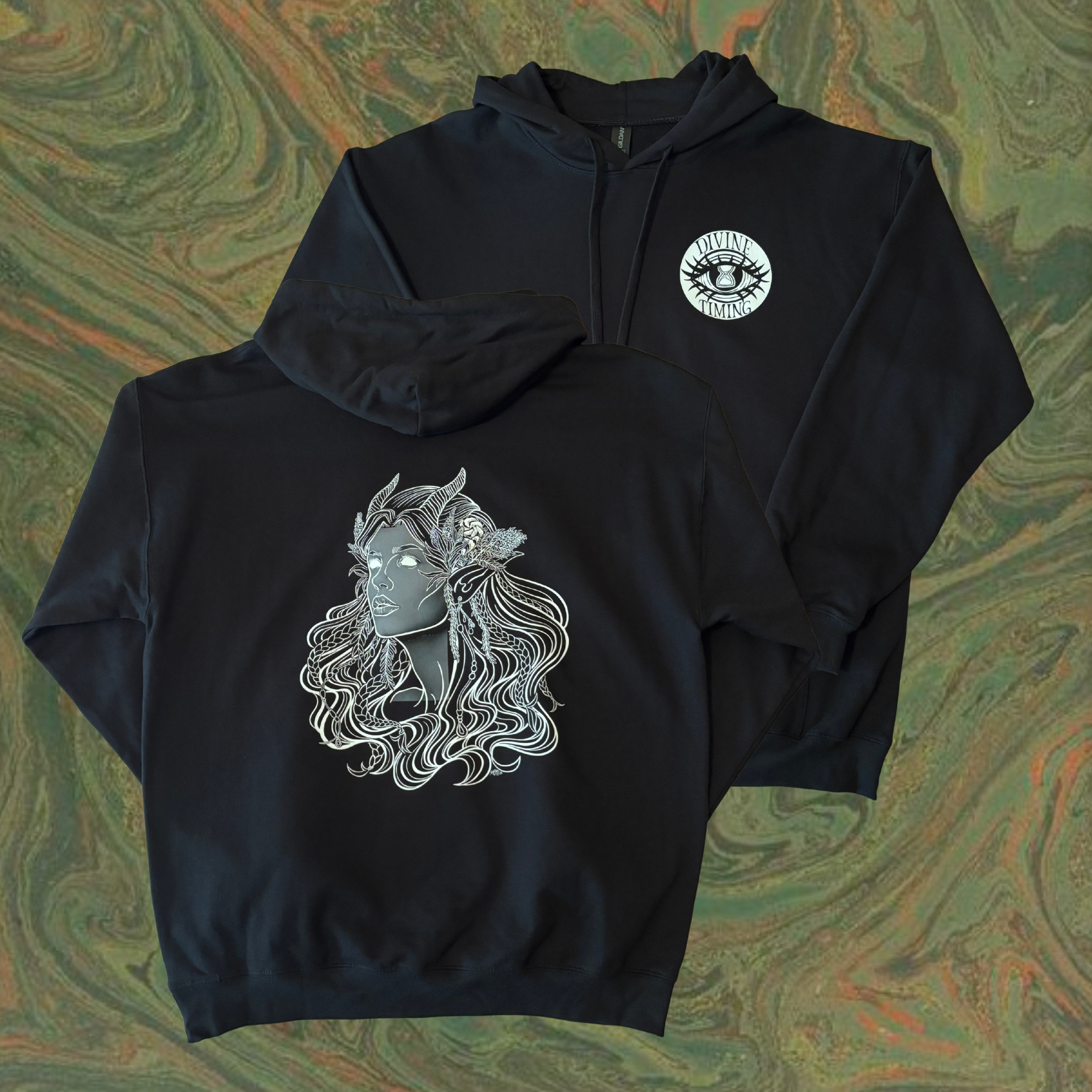 black hoodie showing the Queen of the Forest, a Celtic inspired fae goddess, printed across the back with the Divine Timing Hourglass Eye logo added as a club patch to the front
