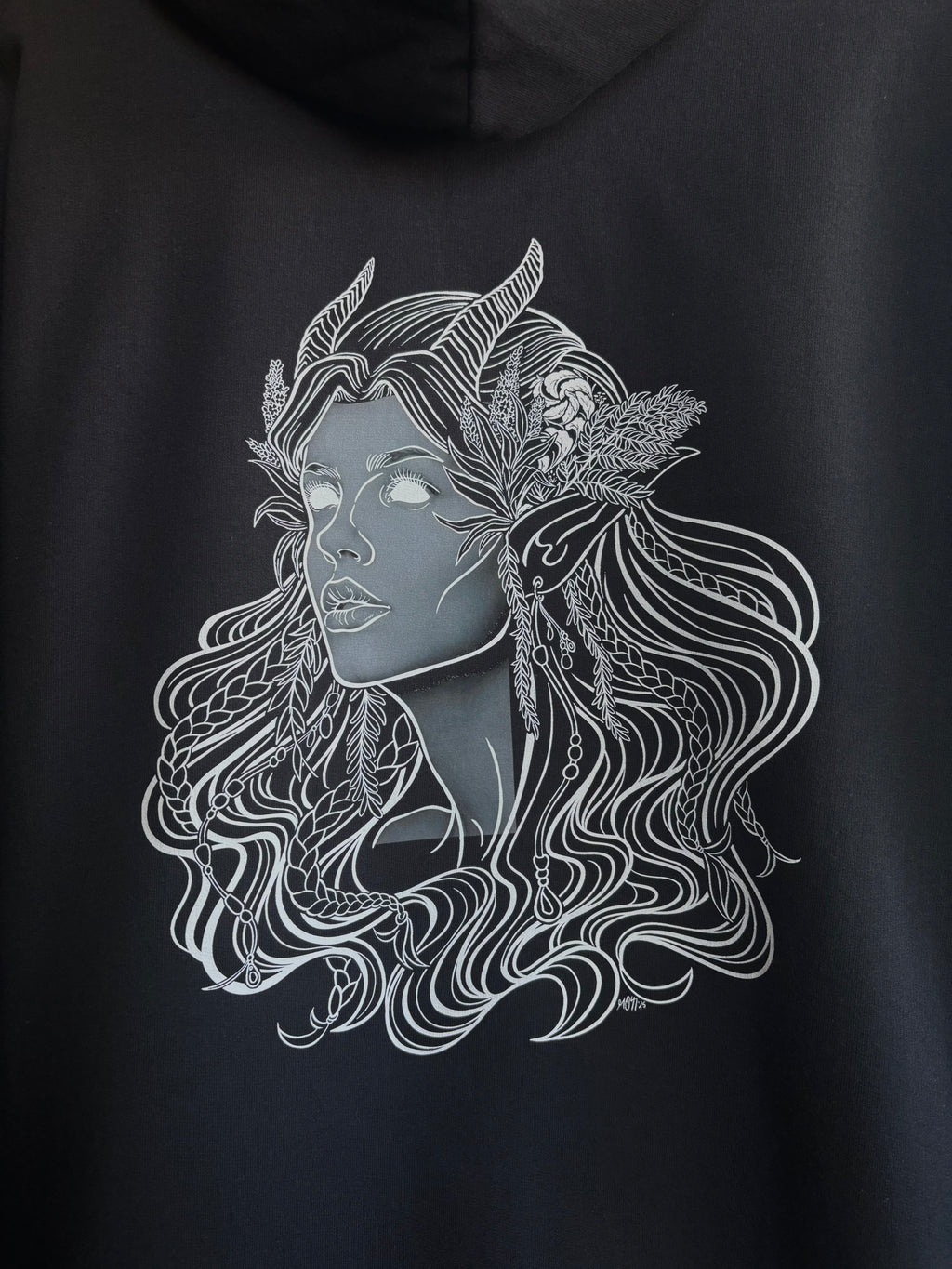 closeup look at the Queen of the Forest printed on the back of a black hoodie
