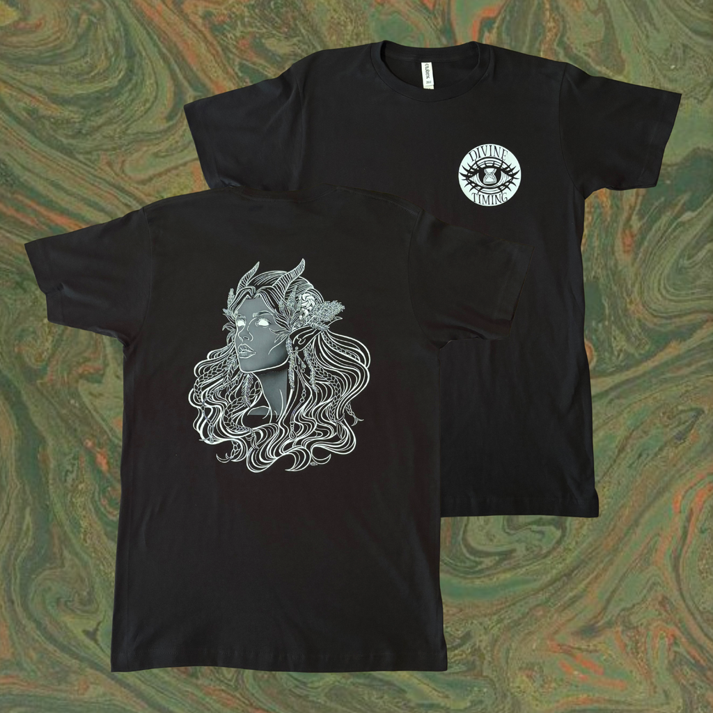 black t-shirt showing the Queen of the Forest, a Celtic inspired fae goddess, printed across the back with the Divine Timing Hourglass Eye logo added as a club patch to the front