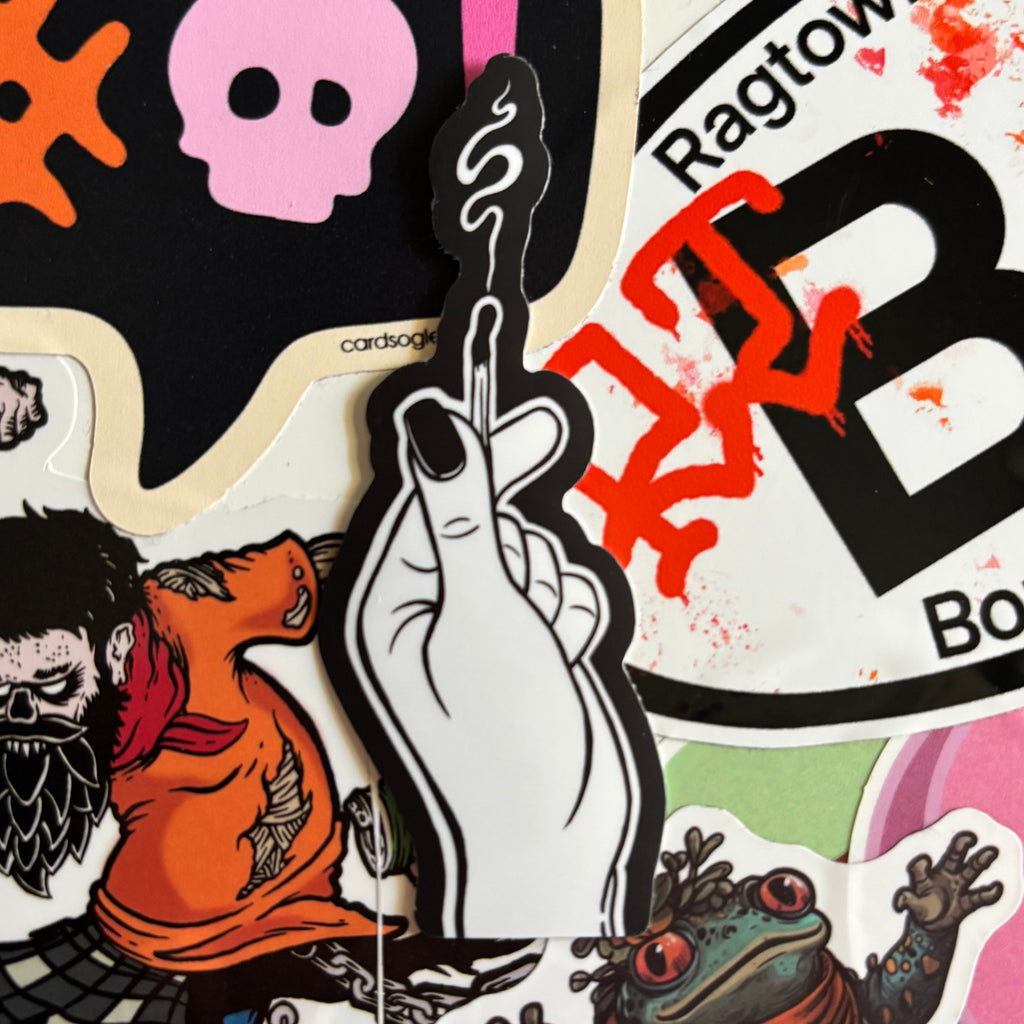 a sticker that shows a hand holding a match that has gone out, with smoke curling up from the end